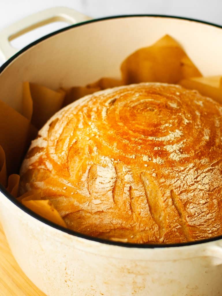 Baked Artisan Bread in a large Dutch oven pot.