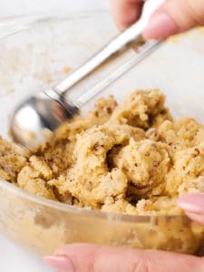 Using a cookie scooper to portion out dough balls.