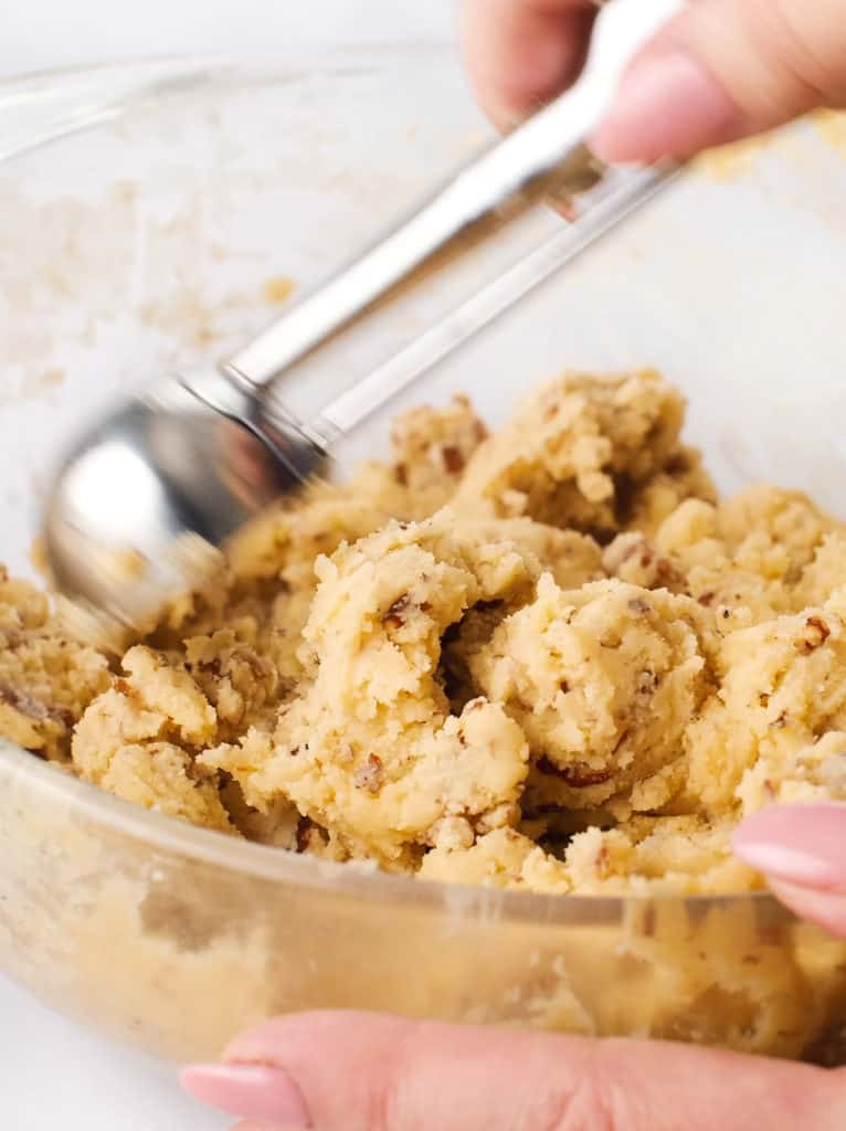 Using a cookie scooper to portion out dough balls.