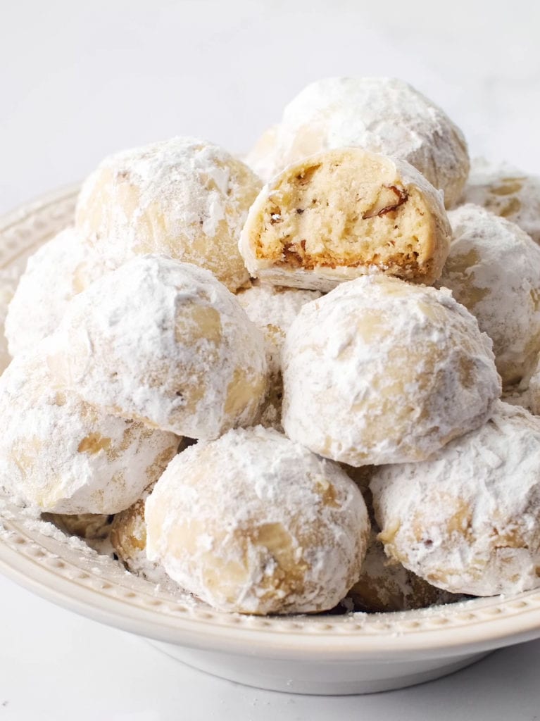 Snowball Cookies arranged in cream colored bowl.