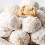 Snowball Cookies arranged in cream colored bowl.