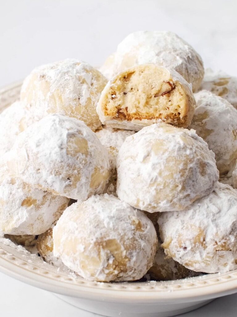 Snowball Cookies arranged in cream colored bowl.