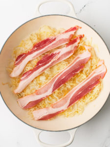 Bottom of pan with sauerkraut and bacon.