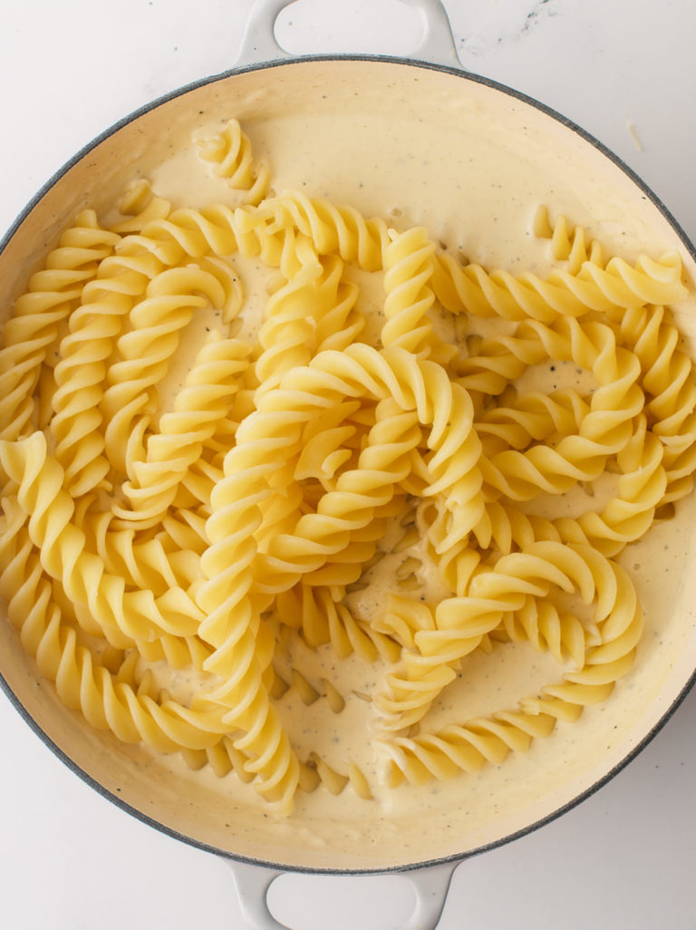 Large, fusilli pasta noodles added to Cacio e Pepe cream sauce.