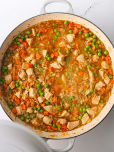 One-Pot Chicken and Rice cooking in a large pan.