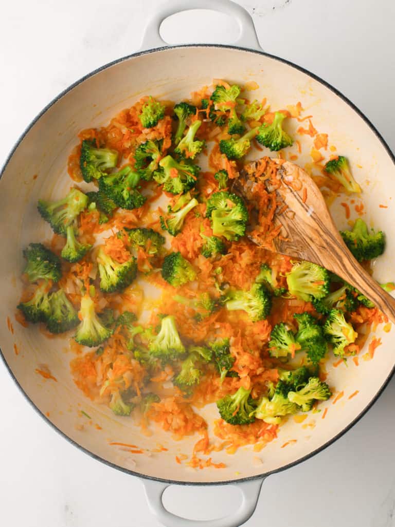 Mirepoix cooking in a large skillet with butter and oil.