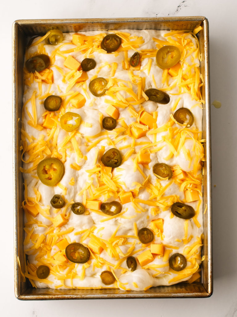 Focaccia dough with cheddar and pickled jalapeño toppings.