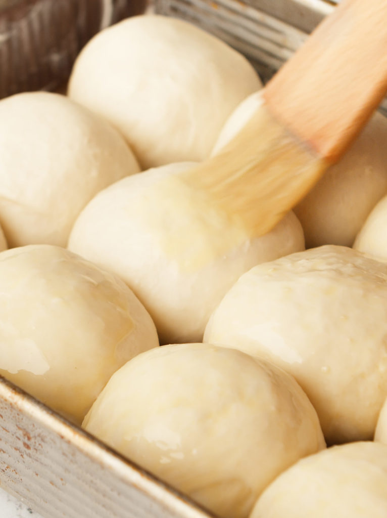 Brushing egg wash in dough.