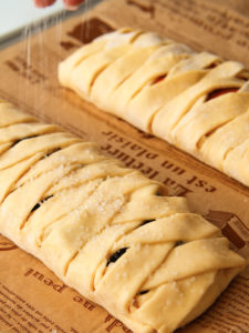 Braided puff pastry on baking tray.