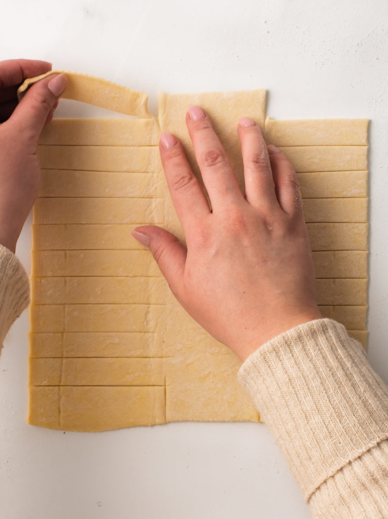 Pulling the excess puff pastry edges off.