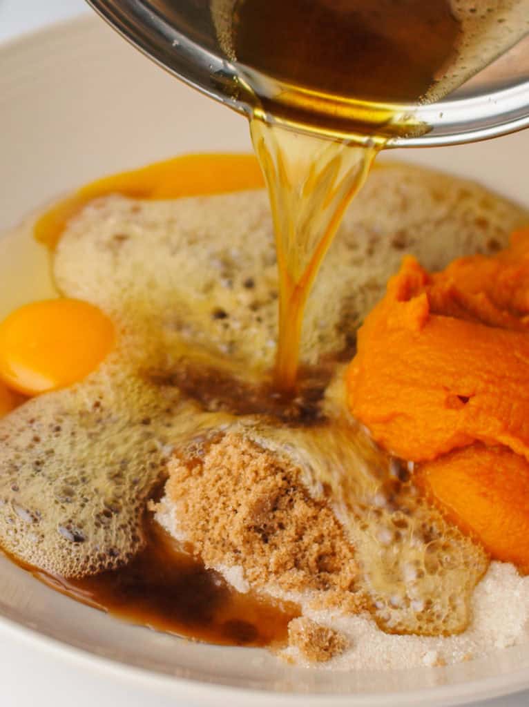 Pouring melted brown butter in mixing bowl.