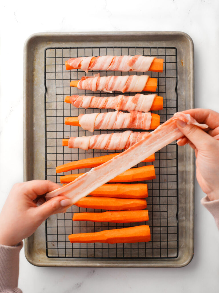 Bacon slice being stretched.