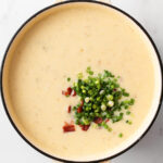 Green onions and bacon toppings in creamy potato soup.