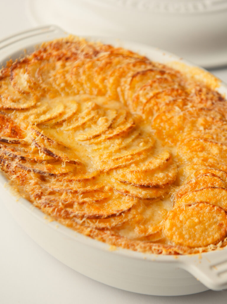 Crispy, golden potatoes in baking tray.