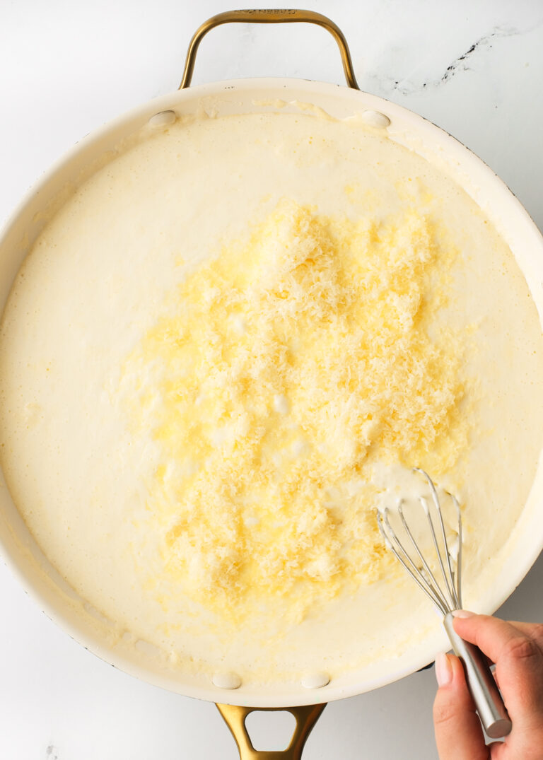 Mixing cheese with cream and butter.