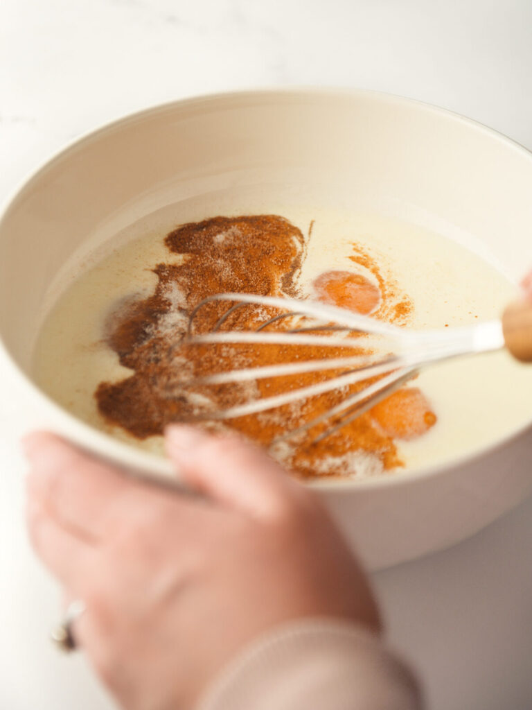 Mixing custard together with a whisk.