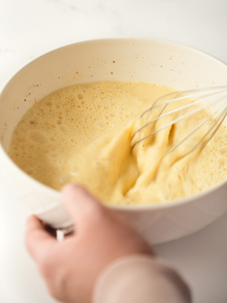 Mixing custard with a whisk.