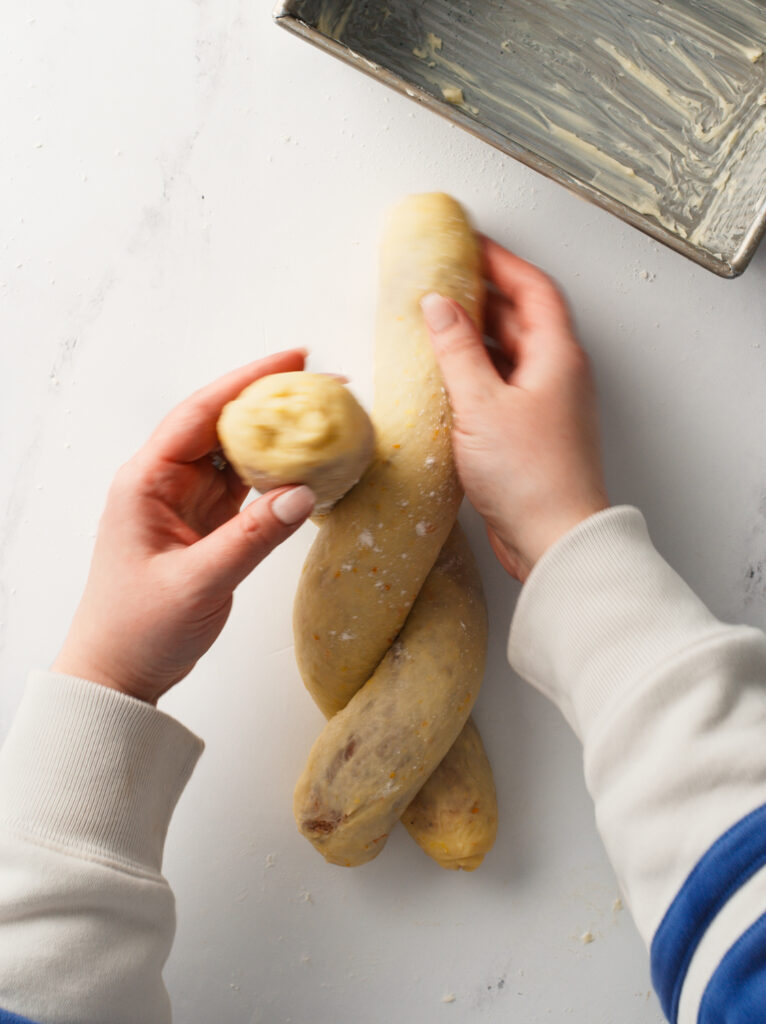 Braiding two pieces of dough together.