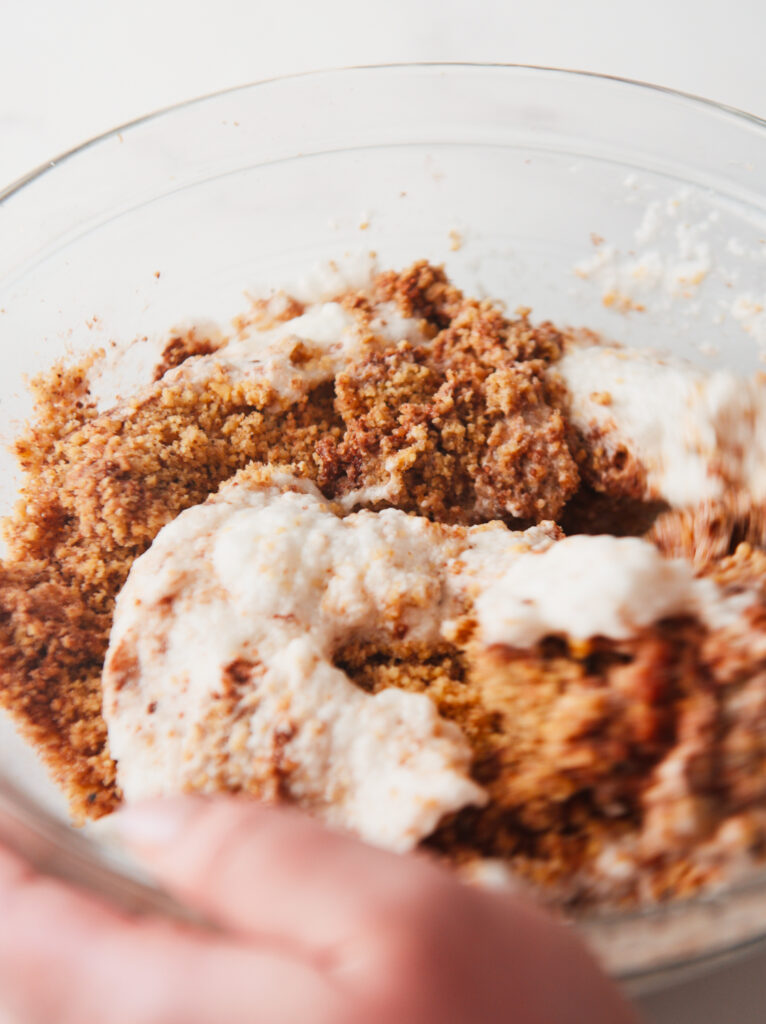 Whipped egg whites being mixed with the walnut filling.