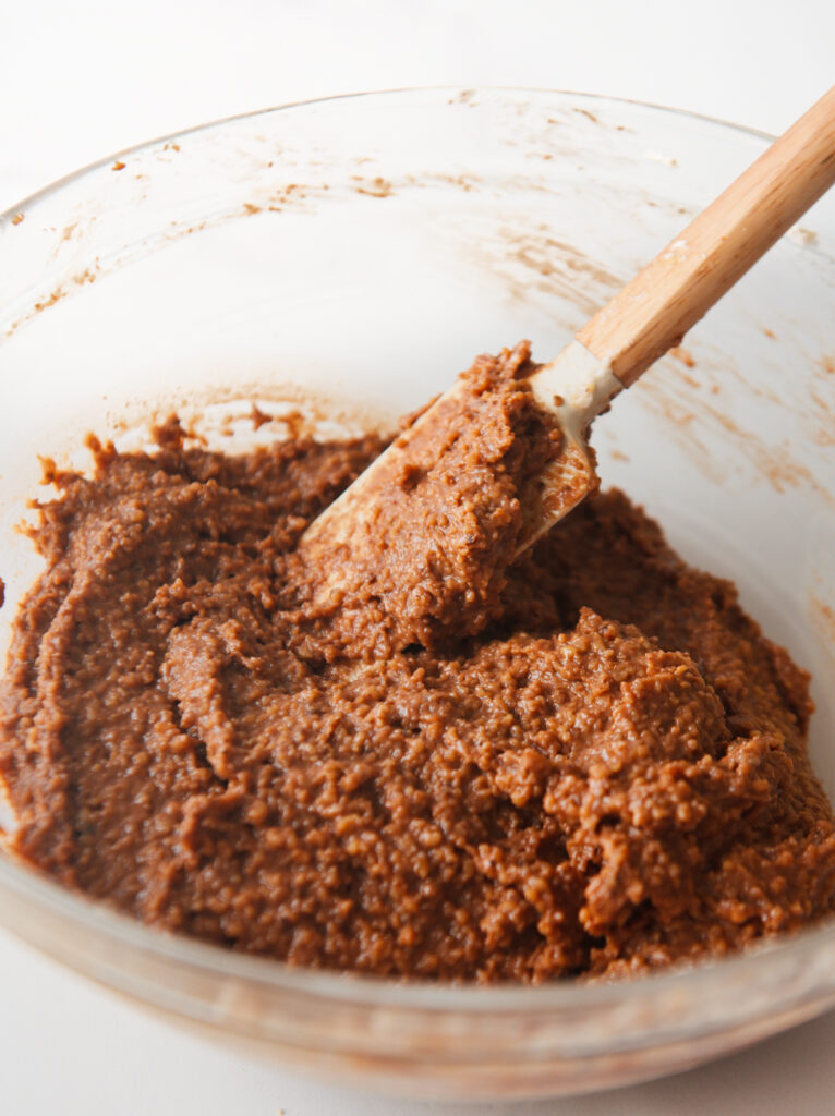 Whipped egg whites being mixed with the walnut filling.