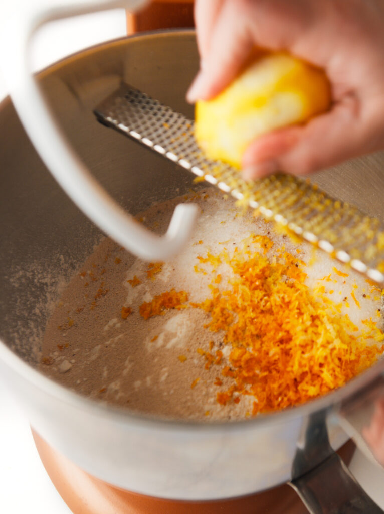 Zesting orange and lemon in Cozonac Babka dough.