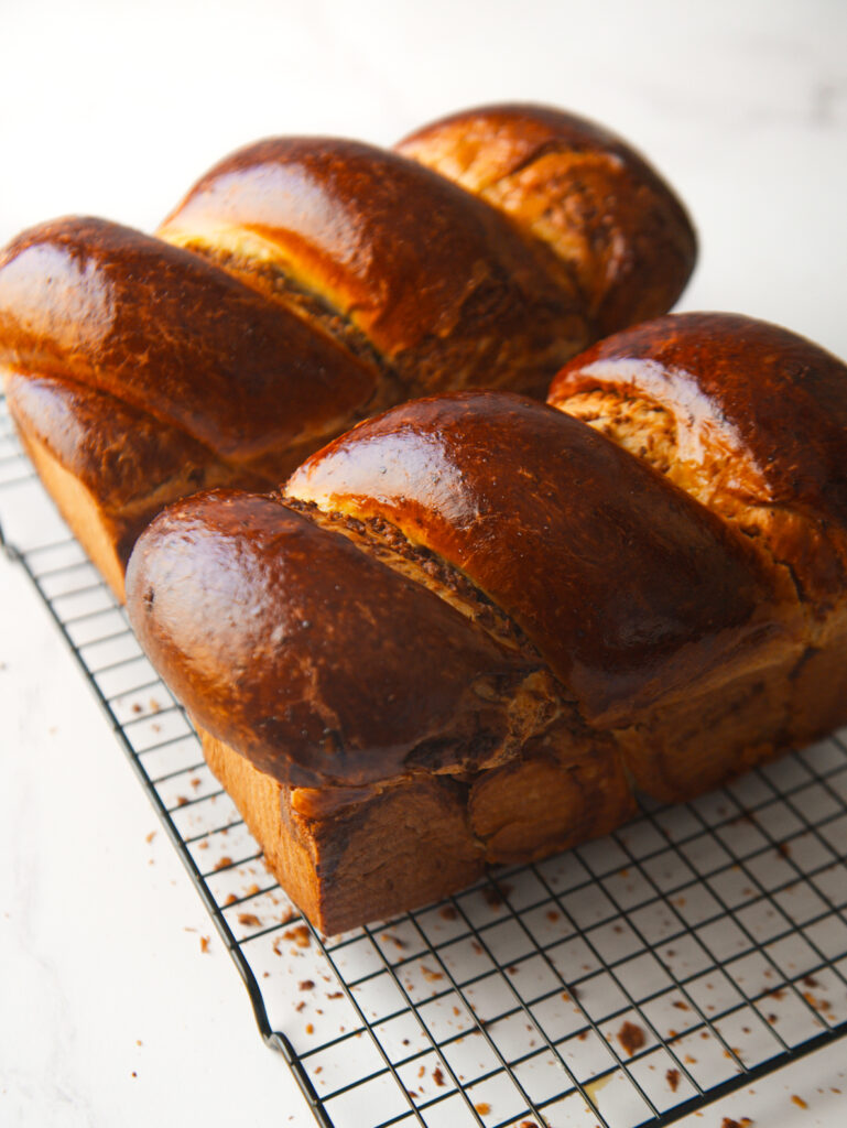 Two Cozonac Babka loaves on a cooling rack.