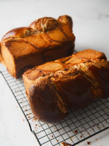 Cozonac Babka laying on its side on cooling rack.