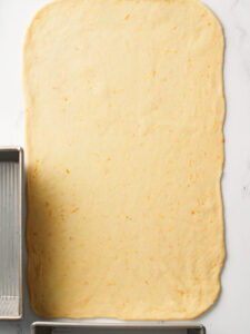 Rolling brioche dough into rectangle.