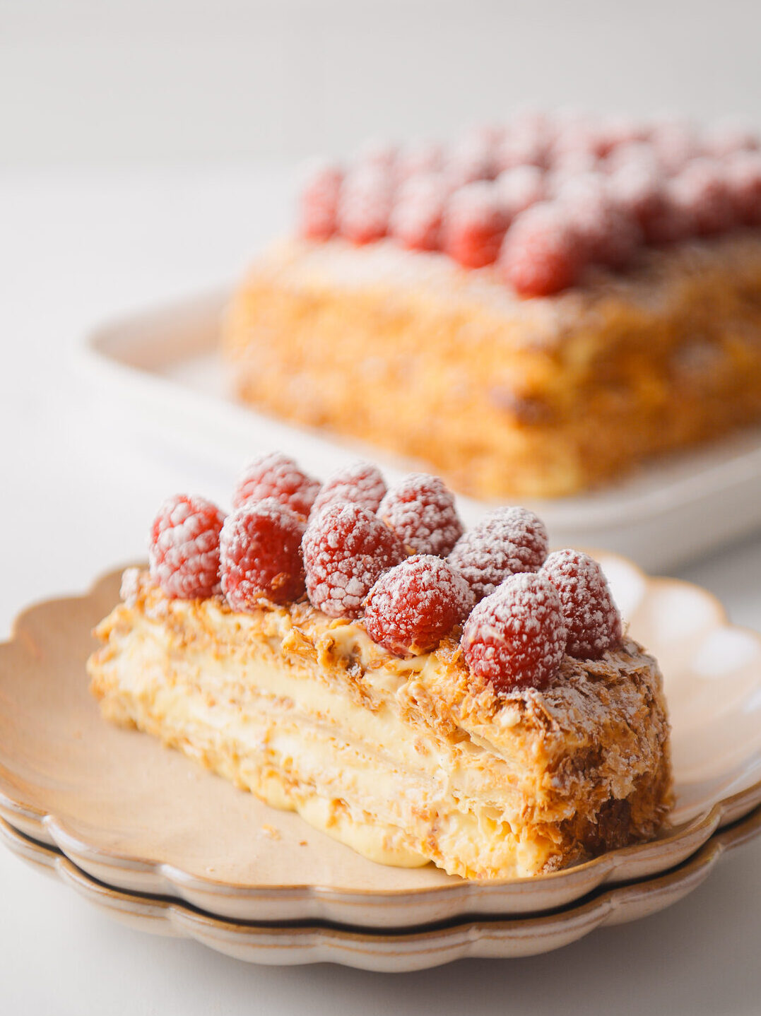 Napoleon Cake slice on scalloped plate.