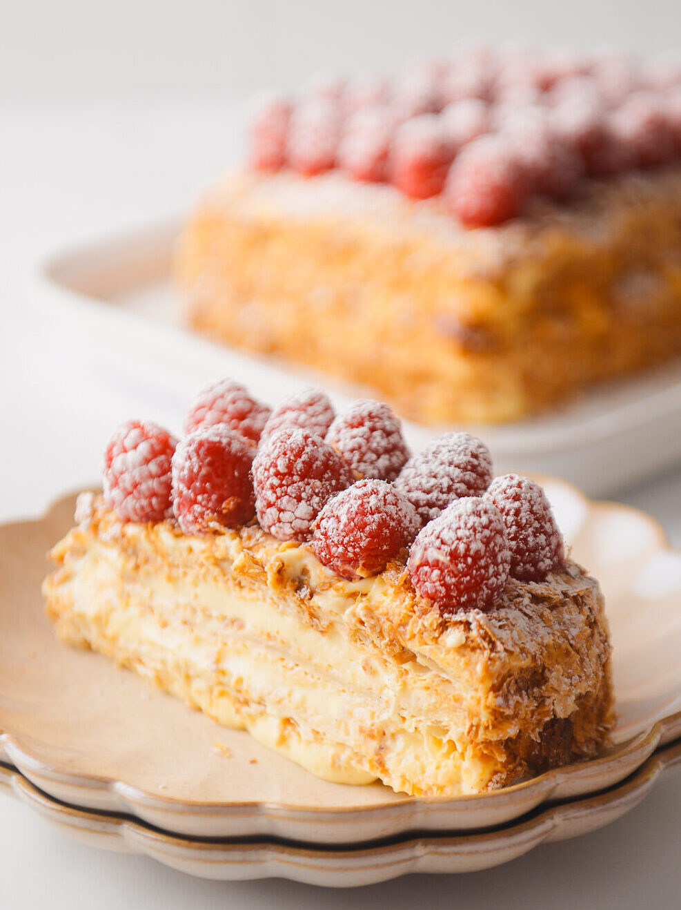 Napoleon Cake slice on scalloped plate.