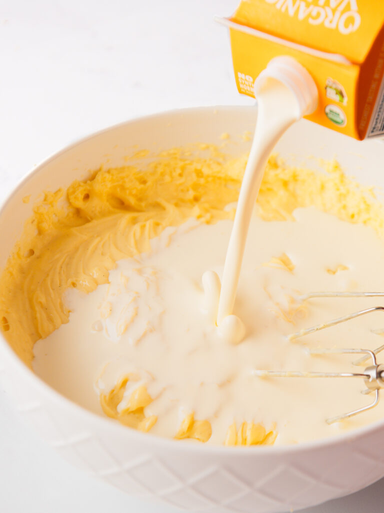 Adding heavy whipping cream to the custard.