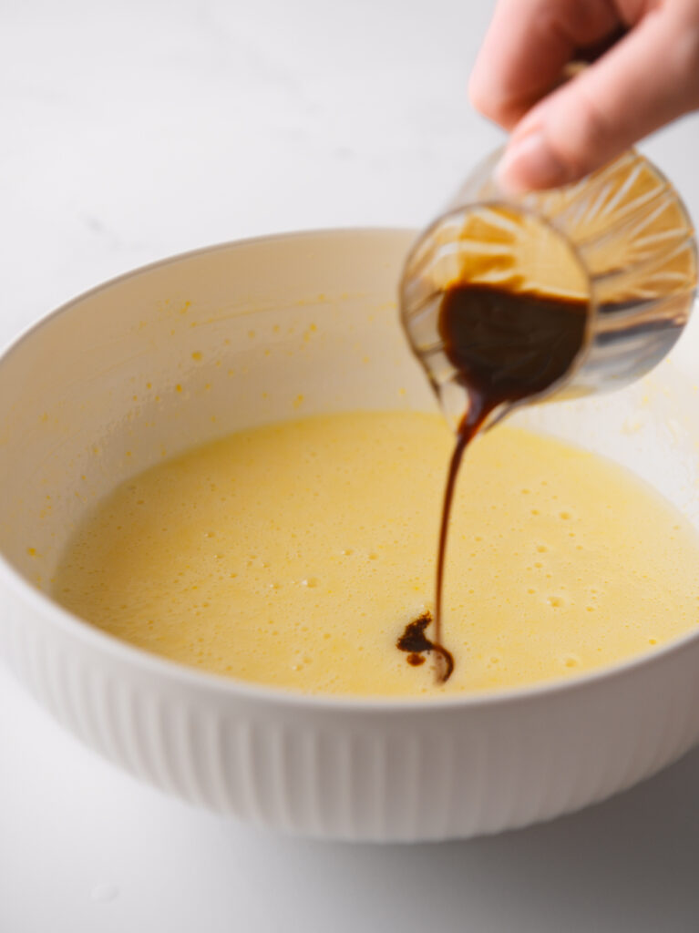 Adding coffee to the cake batter.