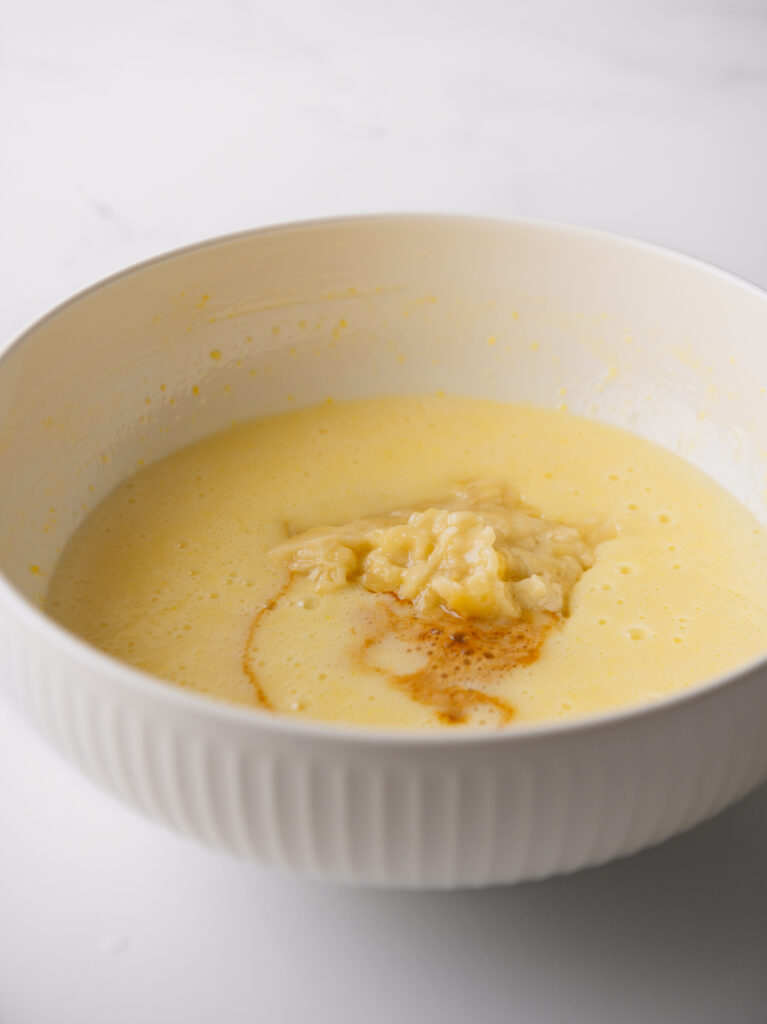 Smashed bananas and coffee in mixing bowl.