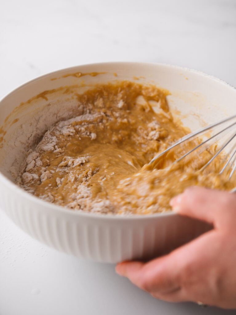 Whisking flour into the batter.