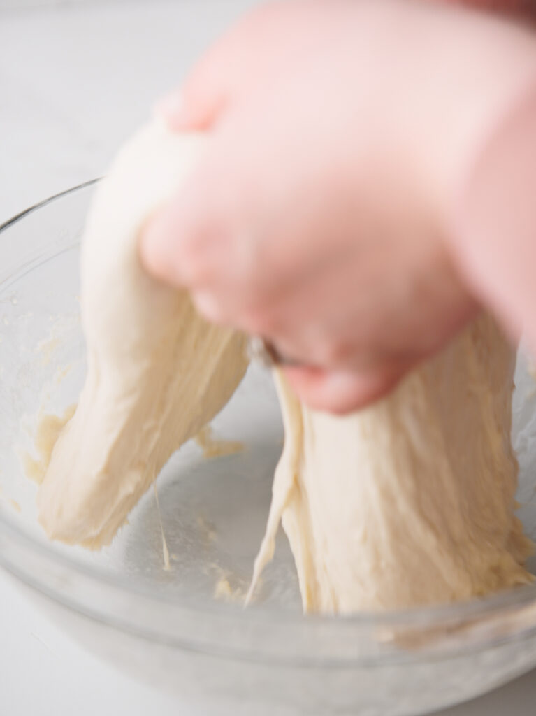 Stretching the soft dough.