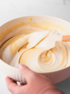 Folding the whipped egg whites into the cake batter.