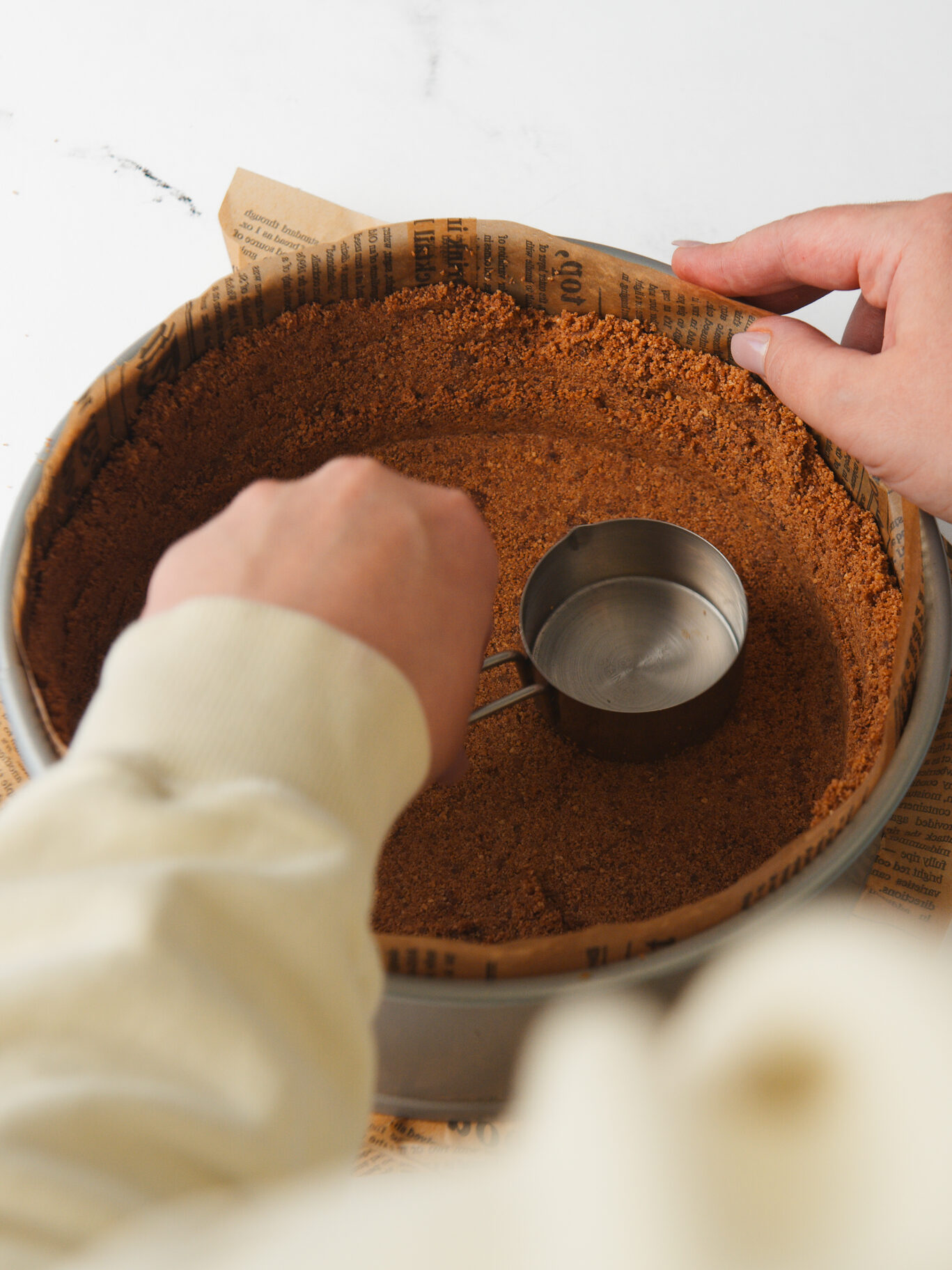 Pressing crust into pan.