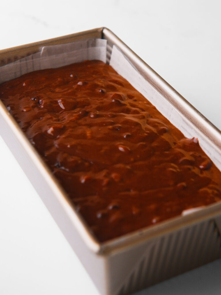 Chocolate batter in loaf pan.