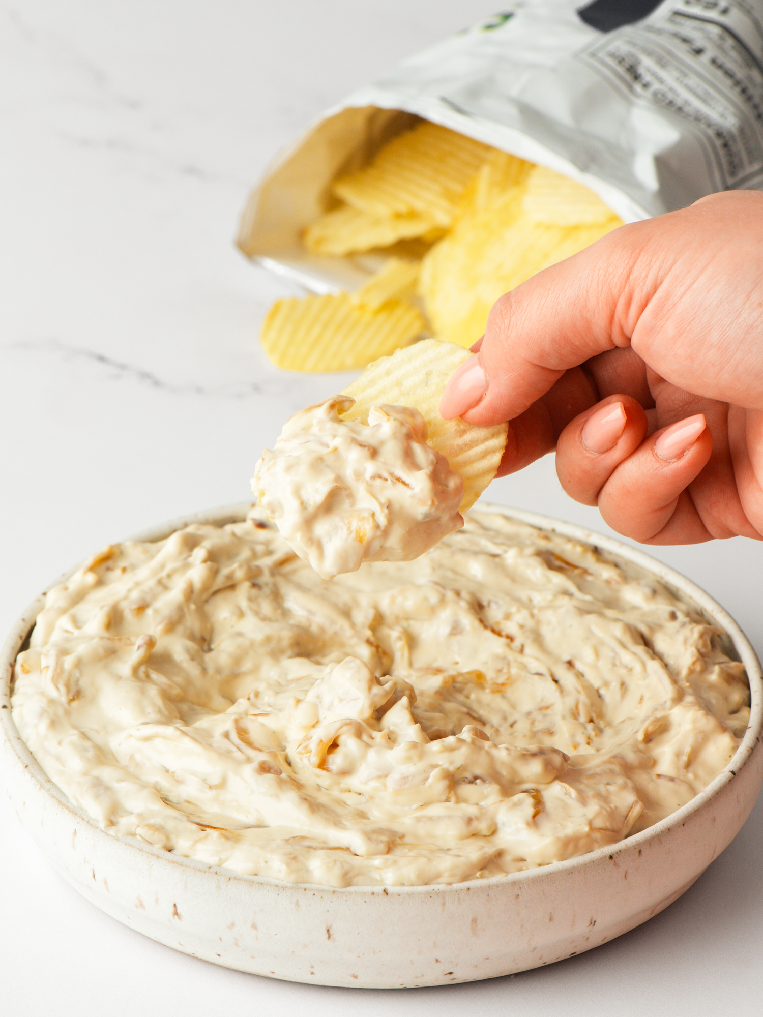 Creamy Caramelized French Onion Dip with chips.