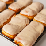 Maple bar donuts on rack with frosting.