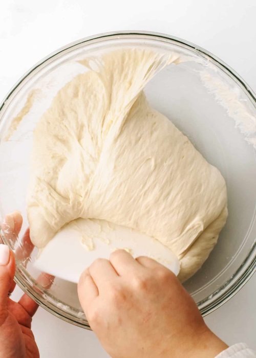 Folding dough into a rough round shape.