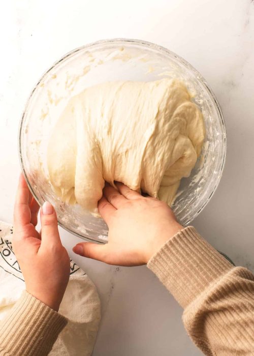 Performing folds of the dough.